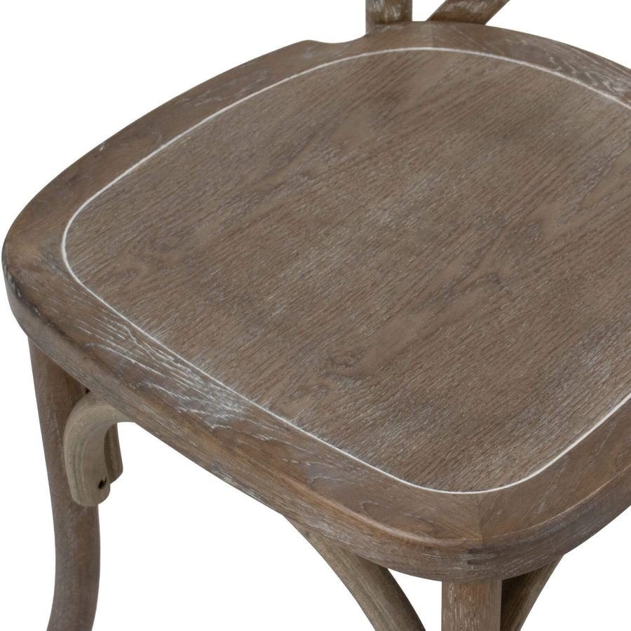 Light oak cross back dining chair with solid oak construction and warm wood grain finish by Sostter at brixbailey.com
