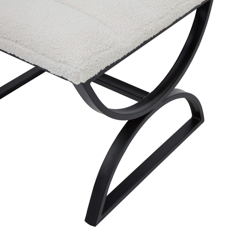 Cream boucle ribbed footstool with black metal frame, curved legs, and textured upholstery for modern interiors by Sostter at brixbailey.com