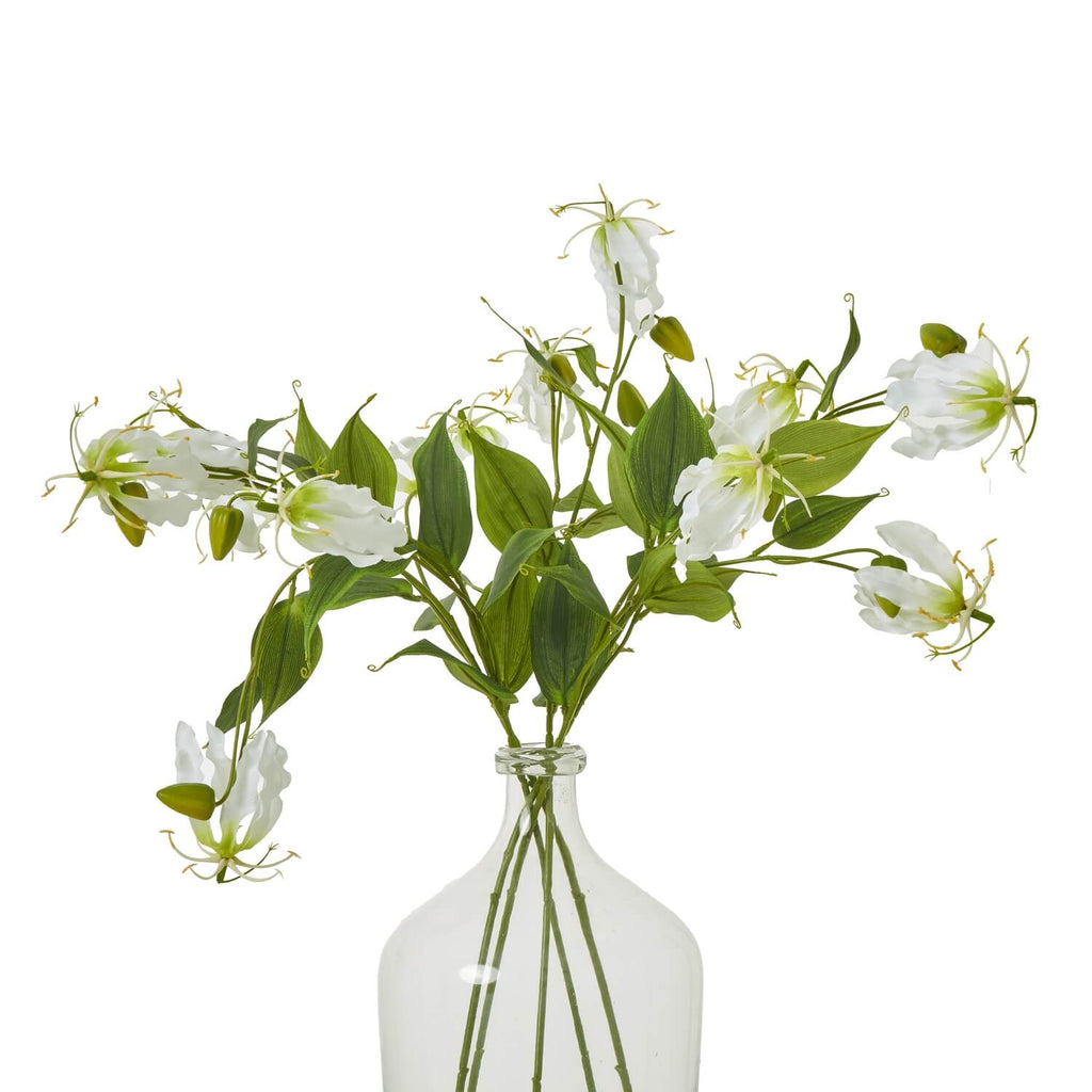 Lifelike white and green Gloriosa Lily floral spray with curling petals, tropical faux flower for home decor by Sostter at brixbailey.com