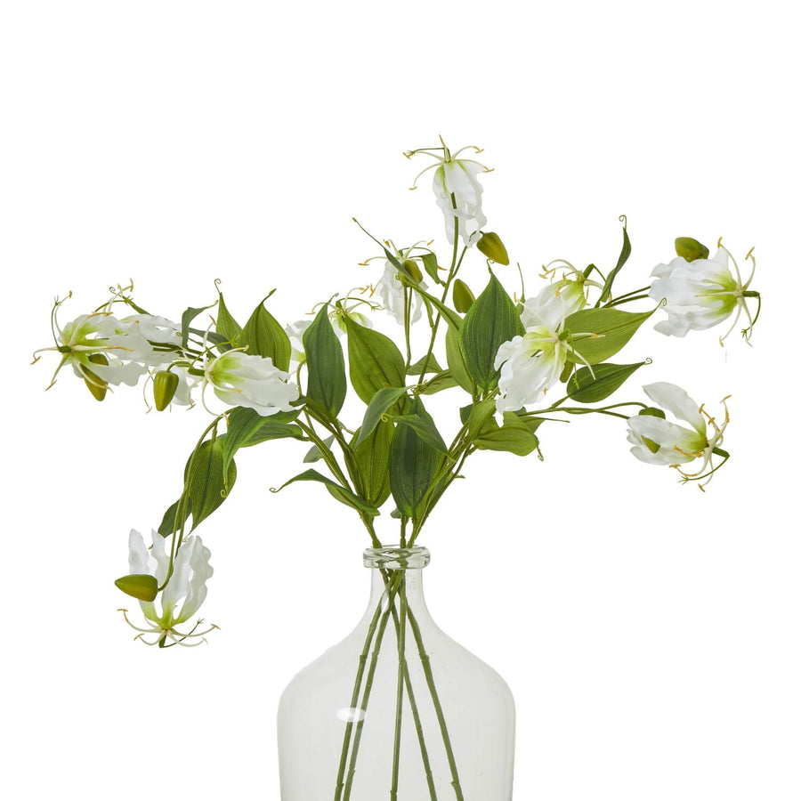 Lifelike white and green Gloriosa Lily floral spray with curling petals, tropical faux flower for home decor by Sostter at brixbailey.com