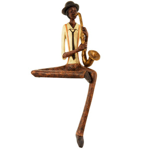 Handcrafted brown resin jazz saxophonist figurine with hanging leg, 38cm tall, for shelf or desk display. by sostter at brixbailey.com