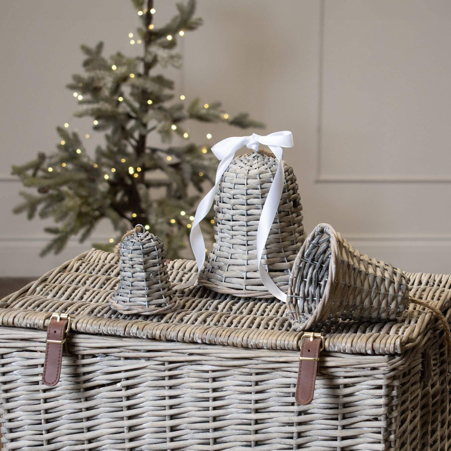 Handwoven wicker holiday bell in rich brown, 15cm tall, casting delicate shadow patterns when lit for festive decor. by Hill Interiors at brixbailey.com