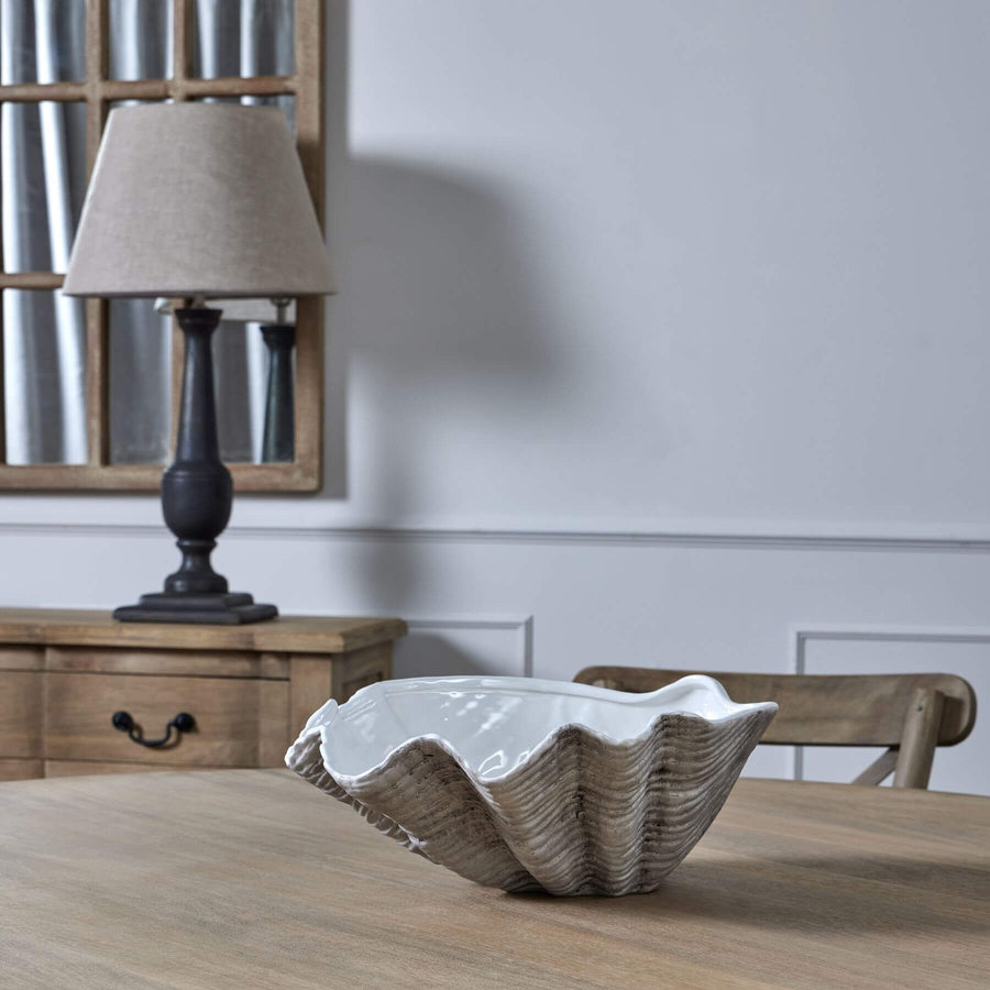 Handcrafted white ceramic shell bowl with organic coastal texture, perfect for floral displays or decor. by Sostter at brixbailey.com