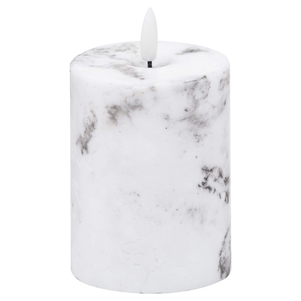 White marble-effect LED pillar candle with realistic flickering amber glow and unique veining patterns. by Sostter at brixbailey.com