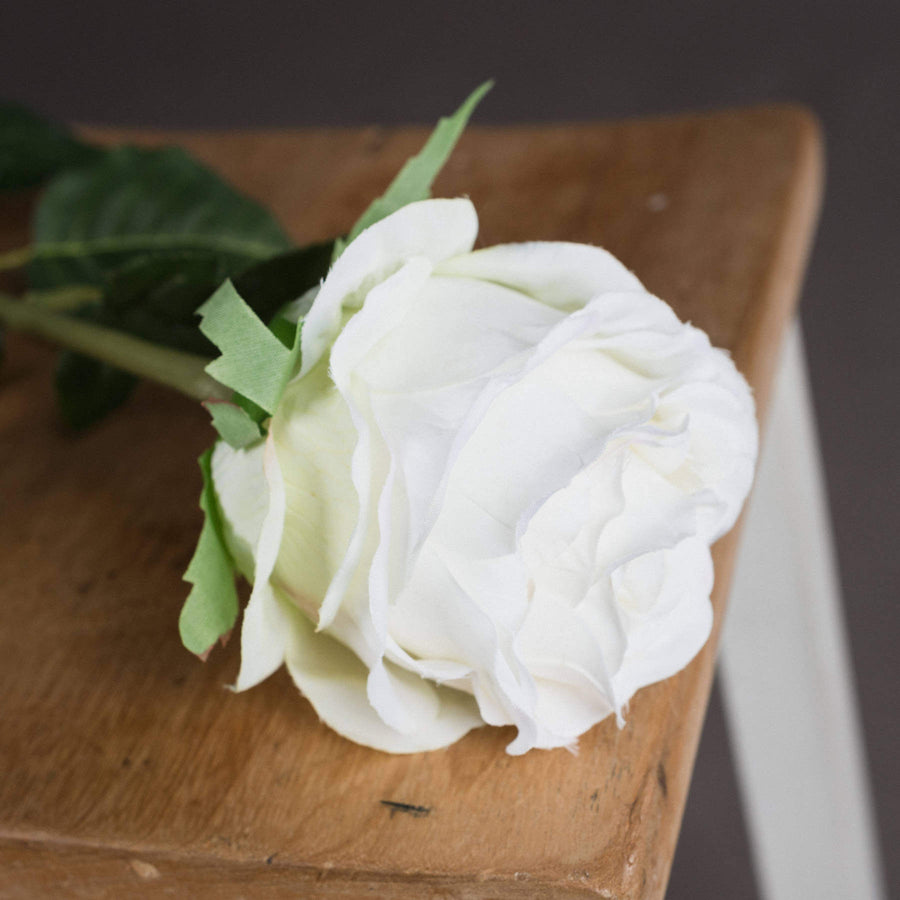 Lifelike white artificial rose stem with realistic petals, perfect for home decor or bouquets by Sostter at brixbailey.com