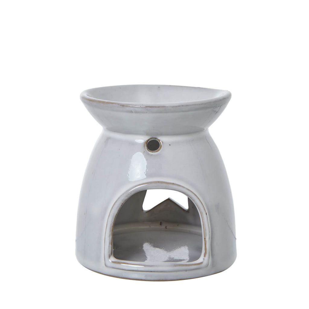 White ceramic tealight holder with star cut-outs, casting enchanting light patterns, for wax melts or candles. by sostter at brixbailey.com