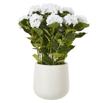 Luxury white faux hydrangea arrangement with velvety petals and lush foliage in a classic farmhouse-style vase by Sostter at brixbailey.com