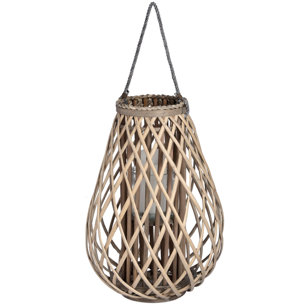 Handwoven rattan lantern with intricate wicker weave in warm brown, creating enchanting light patterns for indoor or outdoor decor. by Sostter at brixbailey.com