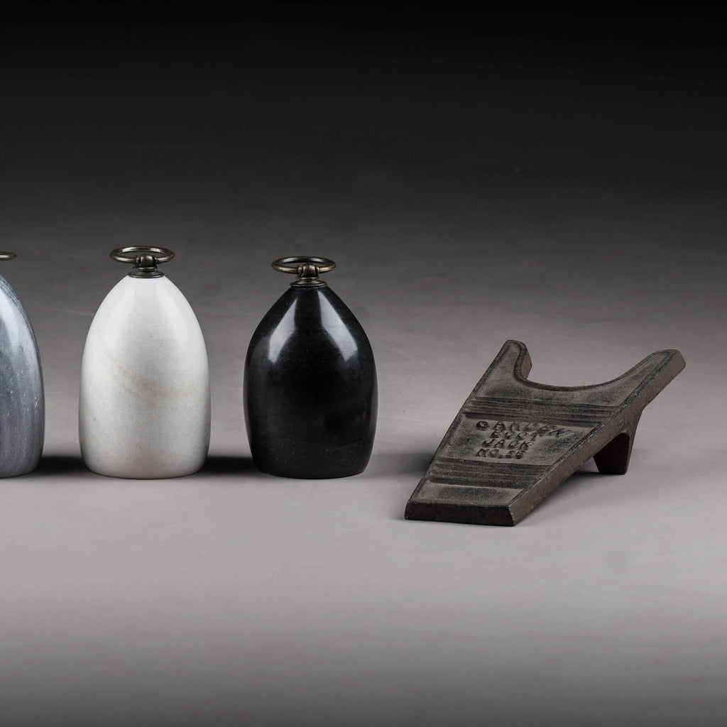 Handcrafted cast iron boot jack in rich brown, rustic texture for effortless boot removal, durable entryway decor by RoomLondon at brixbailey.com