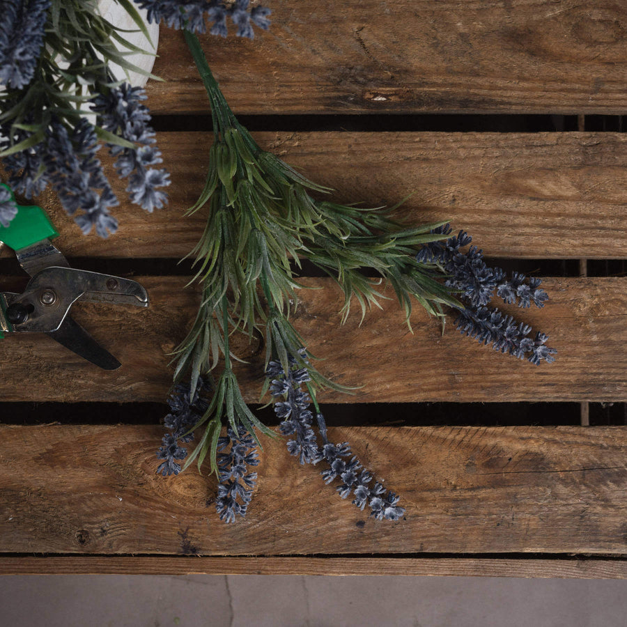 Lifelike faux lavender stems with purple blooms and green accents in a decorative vase, perfect for year-round home decor by Sostter at brixbailey.com