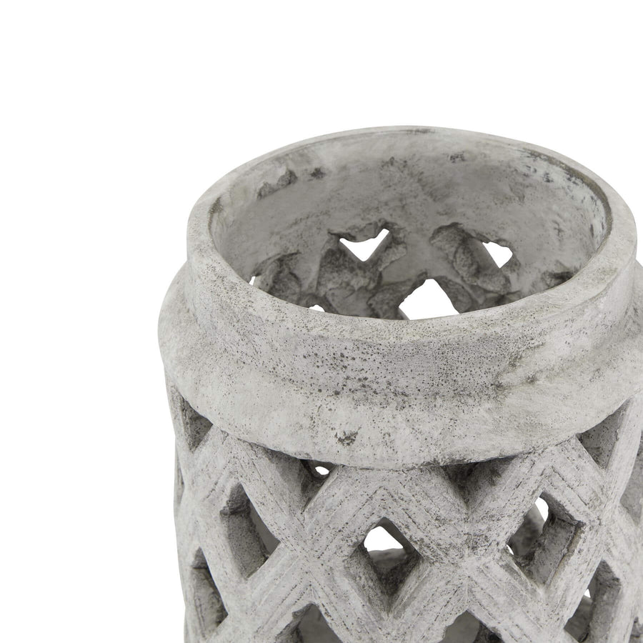 Handcrafted white ceramic Mediterranean lattice lantern with weathered stone finish, casting intricate light patterns by Sostter at brixbailey.com