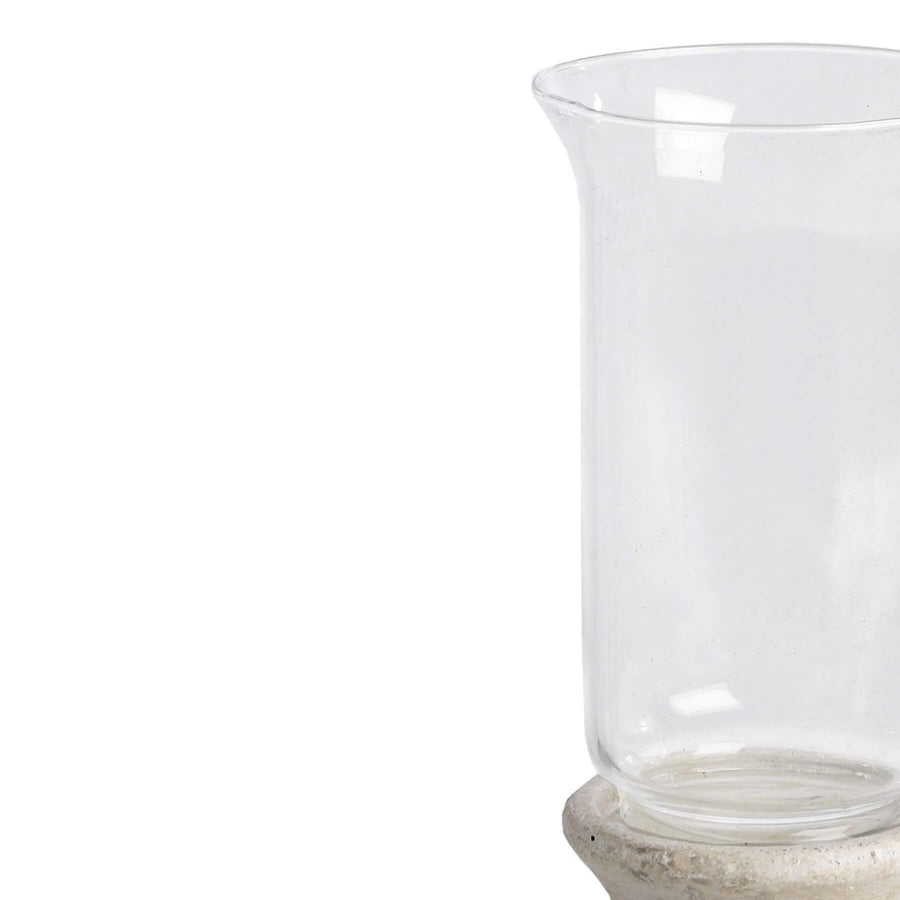 Handcrafted cream hurricane lantern with stone-effect base and antiqued patina, diffusing warm LED candlelight. by Sostter at brixbailey.com