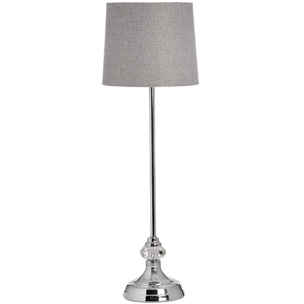 Silver designer table lamp with chrome base, glass accents, and herringbone fabric shade for warm, elegant lighting by Sostter at brixbailey.com