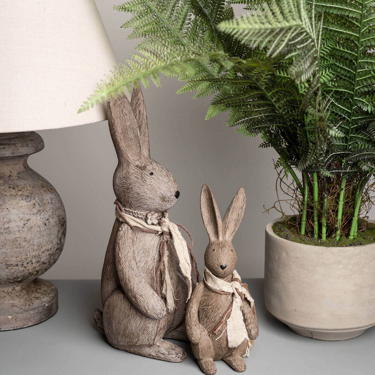 Handcrafted winter bunny figurine with fabric scarf, warm brown resin decor for shelves or mantels by Sostter at brixbailey.com