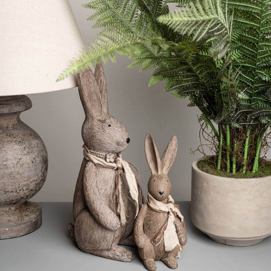 Handcrafted winter bunny rabbit resin figurine in warm brown, sitting pose with lifelike details, perfect for home decor. by Hill Interiors at brixbailey.com