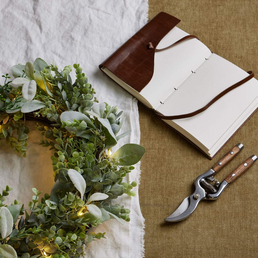 Handcrafted LED winter wreath with eucalyptus and lambâ€™s ear foliage, glowing natural green with silvery accents. by Sostter at brixbailey.com