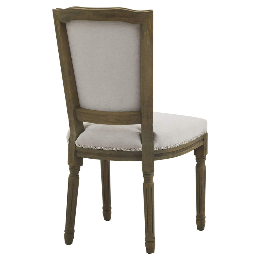 Grey Ripley dining chair with handcarved rubberwood frame and neutral woven upholstery, ergonomic design (124 chars) by Sostter at brixbailey.com