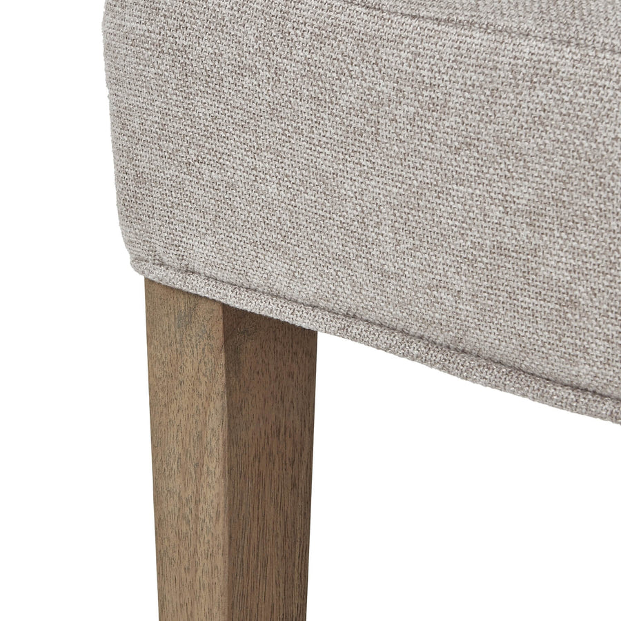 Oatmeal twill dining chair with tufted detailing, curved back, and solid oak legs for elegant comfort. by Sostter at brixbailey.com