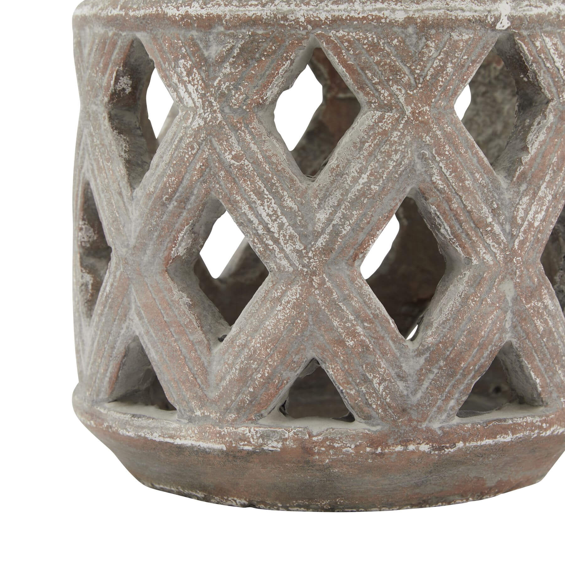 Brown ceramic lattice lantern with geometric diamond-cut patterns, casting mesmerizing light displays on tabletop. by Sostter at brixbailey.com