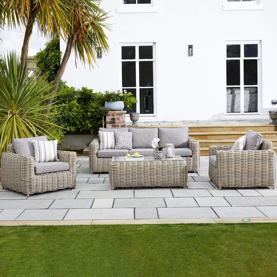 Premium beige HDPE wicker outdoor patio set with Olefin cushions and aluminum frame, includes coffee table by Hill Interiors at brixbailey.com