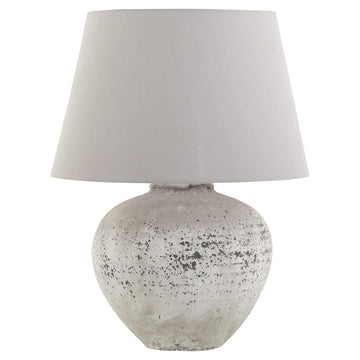 Handcrafted stone-effect ceramic lamp with light grey fabric shade, organic texture, and warm ambient glow by Sostter at brixbailey.com