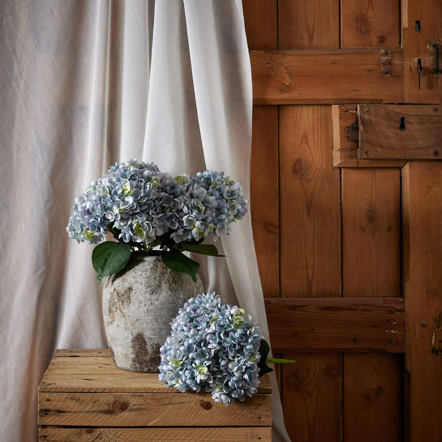 Handcrafted blue hydrangea stems in rich hue, lifelike plastic petals, perfect for vases and home decor. by Sostter at brixbailey.com