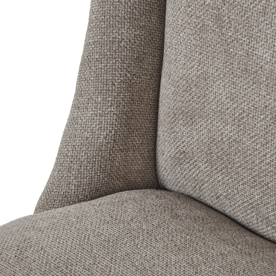 Handwoven taupe dining chair with solid wood frame, ergonomic curved silhouette, and dark wood accents. by Sostter at brixbailey.com