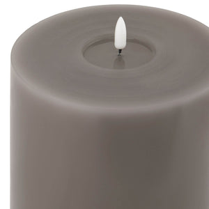 Grey LED wax candle with realistic dripping effect and warm flickering glow, safe flameless decor for modern interiors. by sostter at brixbailey.com