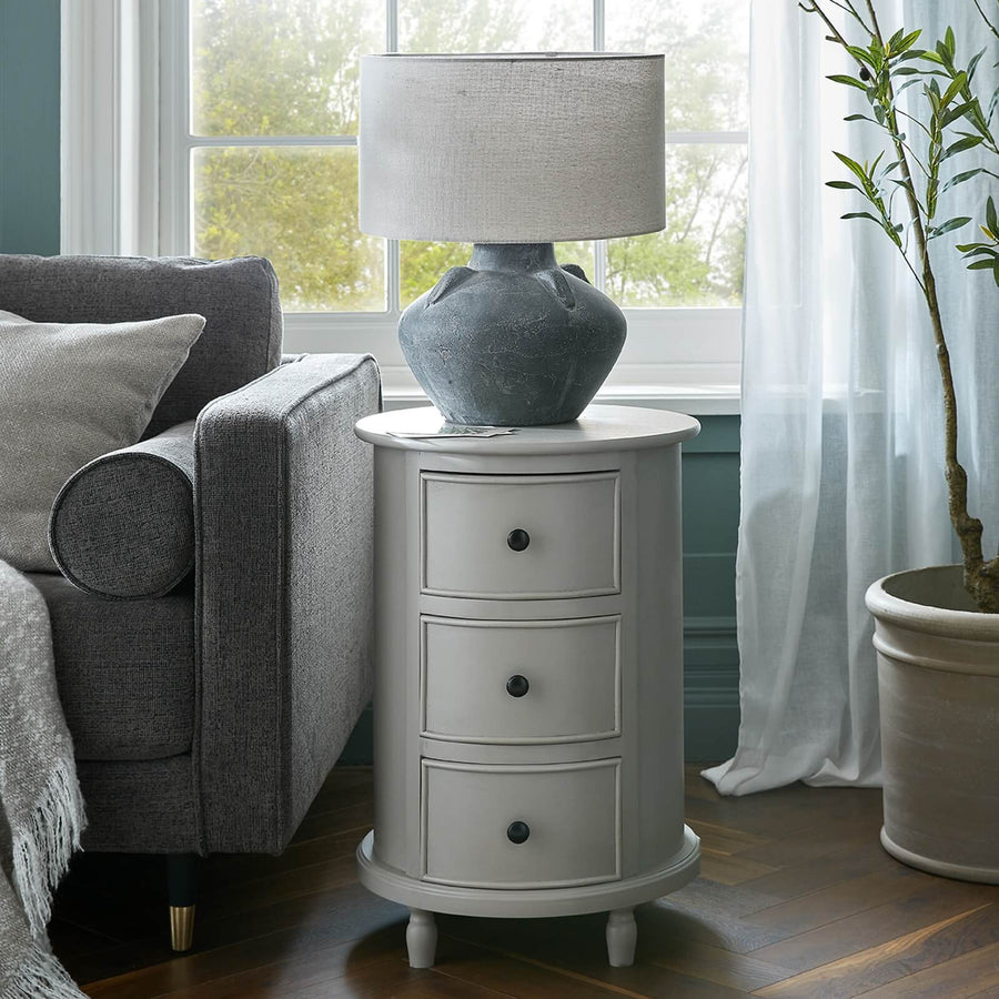 Modern grey round side table with three hidden drawers, solid wood construction, 45cm diameter by Sostter at brixbailey.com