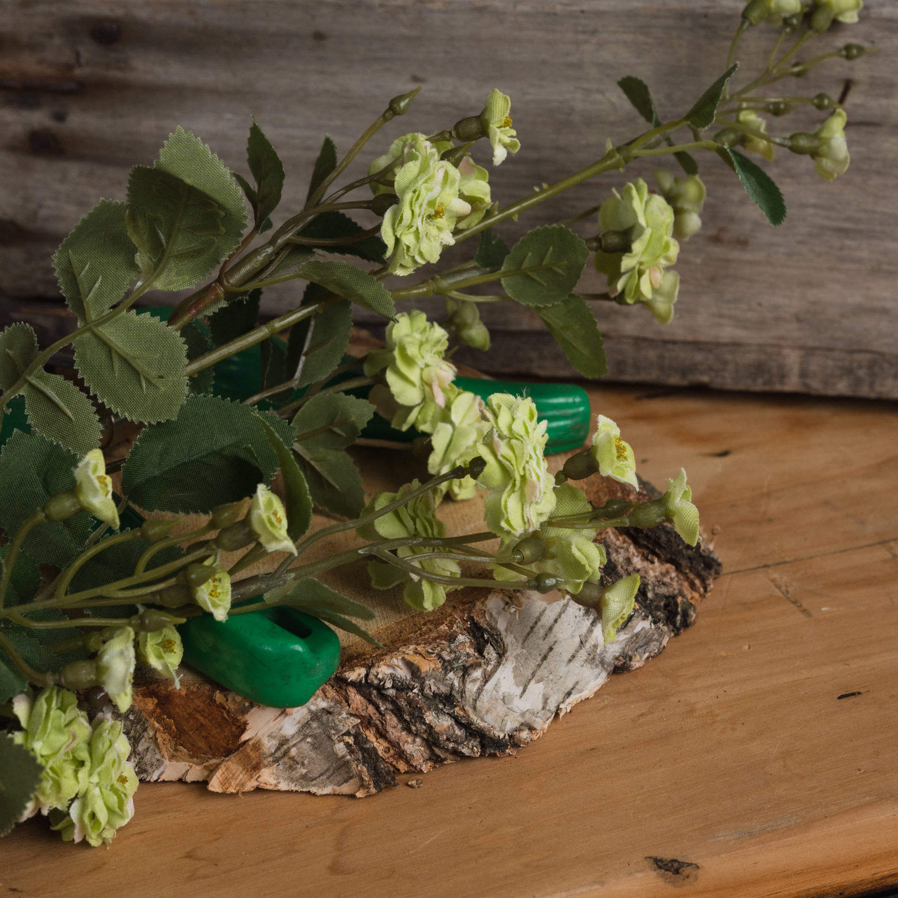 Lifelike artificial meadow rose in rich botanical green, high-quality plastic, 74cm tall, perfect for home decor by Sostter at brixbailey.com