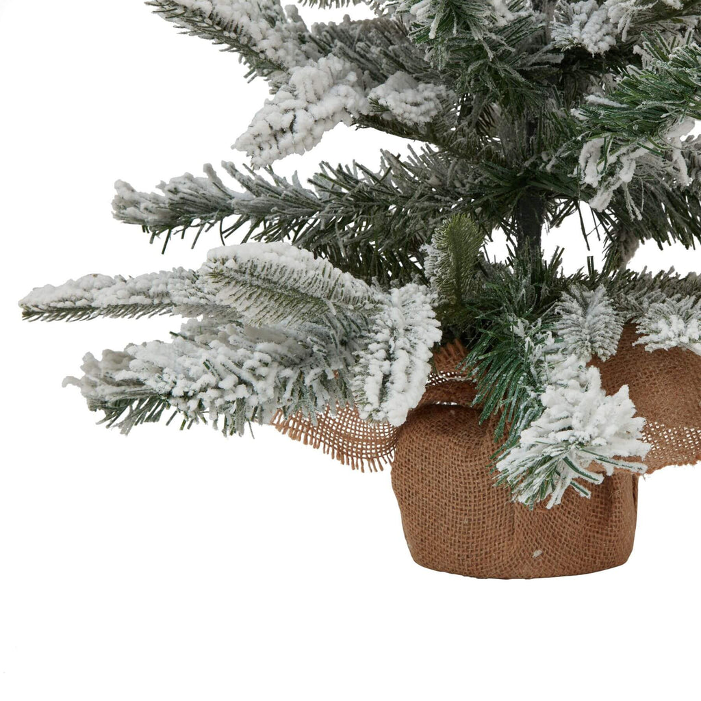 Medium snowy spruce tree with frosted white branches and rustic burlap base for winter decor  by Sostter at brixbailey.com