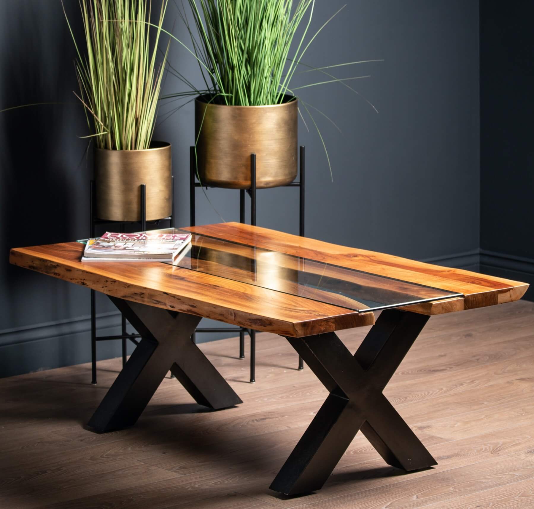Live edge river dining table with tempered glass center and natural wood edges, warm brown tones, modern rustic design. by Sostter at brixbailey.com