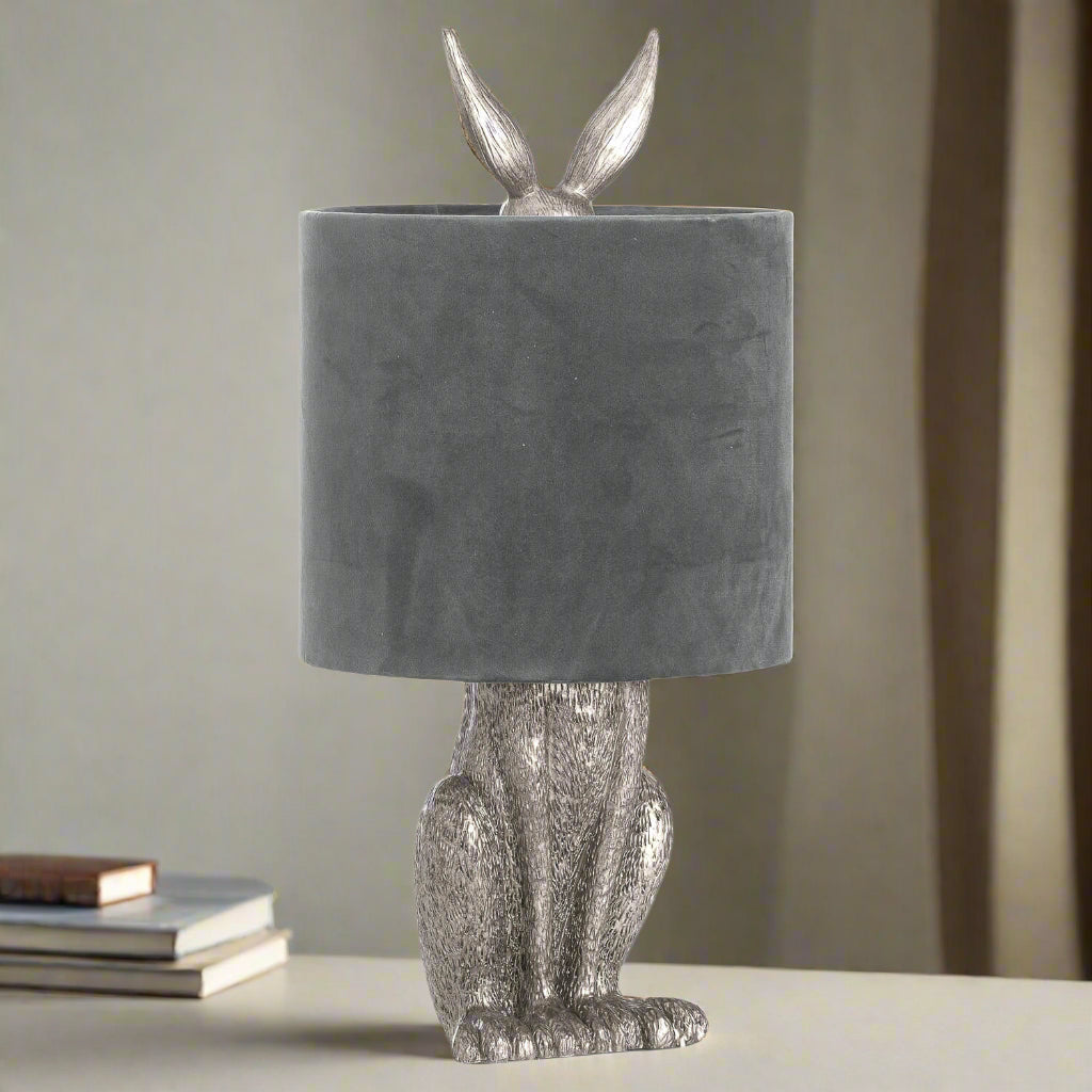 Silver Hare Table Lamp with grey velvet shade, handcrafted resin sculpture, and sophisticated silver finish. by Sostter at brixbailey.com