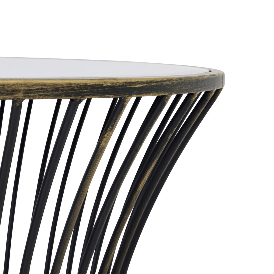 Handcrafted brass side table with black patina finish, mirrored glass top, and concave silhouette for modern interiors. by Sostter at brixbailey.com