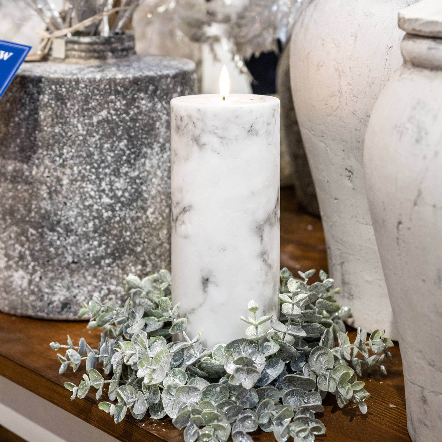 Handcrafted white marble-pattern LED candle with flickering amber flame, real wax exterior, and unique veining. by Sostter at brixbailey.com