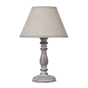 Rustic table lamp with weathered gray-washed wood base and natural linen shade for farmhouse or industrial decor.by Sostter at brixbailey.com