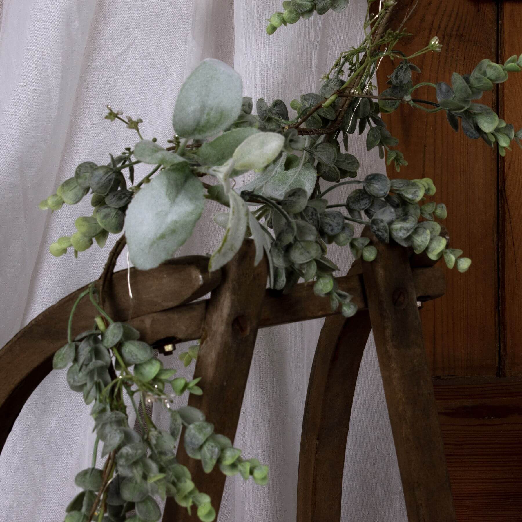 Frosted eucalyptus LED garland with silver accents, 5 feet long, battery-operated winter decor for mantels or staircases by Sostter at brixbailey.com