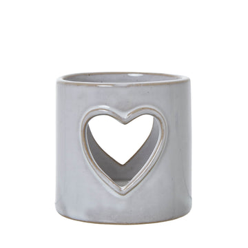 White ceramic tealight holder with heart cutouts, casting romantic light patterns, perfect for home decor and ambiance. by Hill Interiors at brixbailey.com