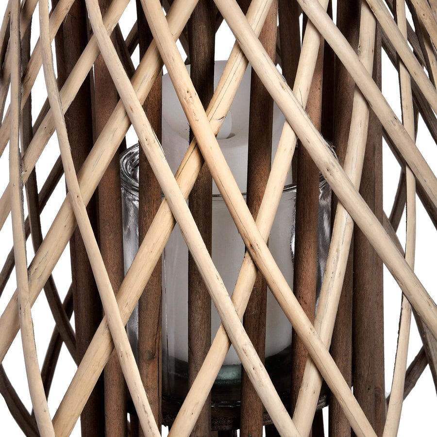 Handwoven rattan lantern with warm brown tones, creating enchanting light patterns for indoor or outdoor decor. by Sostter at brixbailey.com