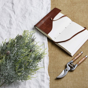Lifelike frosted pine spray with winter white accents and pinecones for seasonal home dÃ©cor by Sostter at brixbailey.com