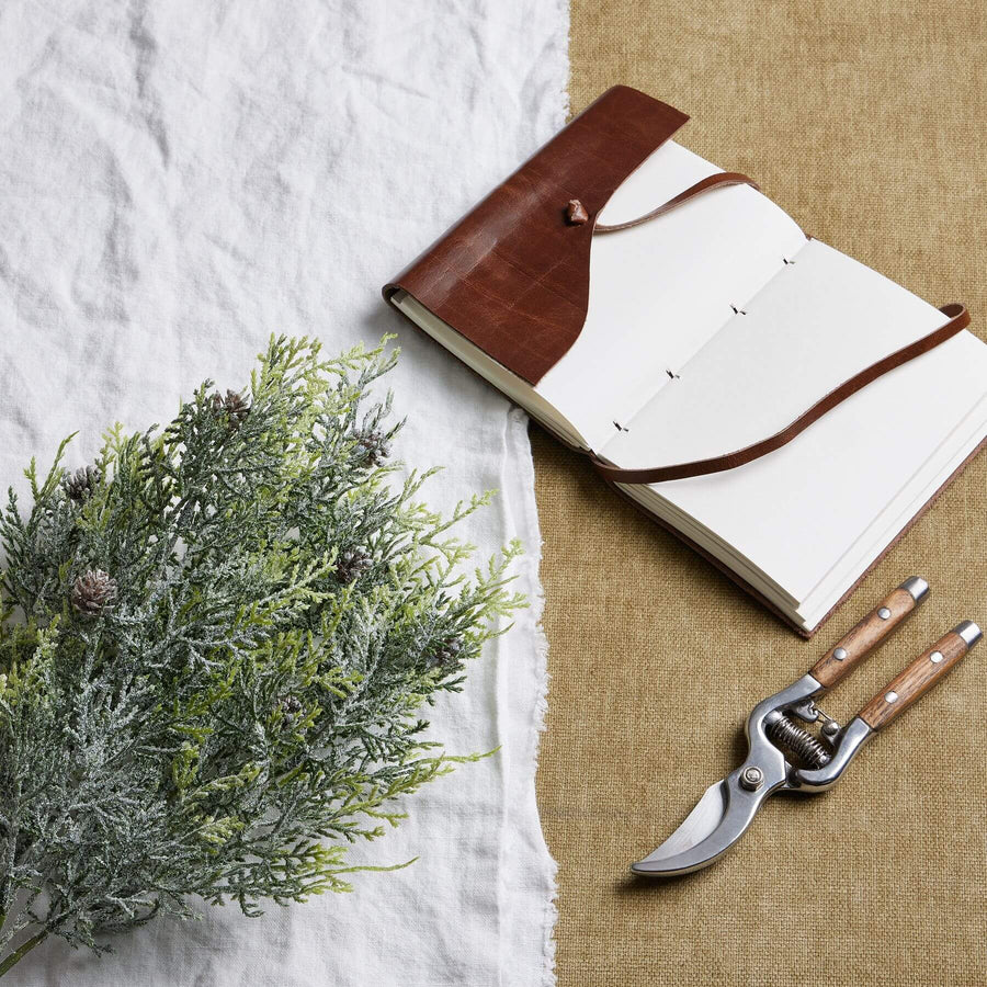 Lifelike frosted pine spray with winter white accents and pinecones for seasonal home dÃ©cor by Sostter at brixbailey.com
