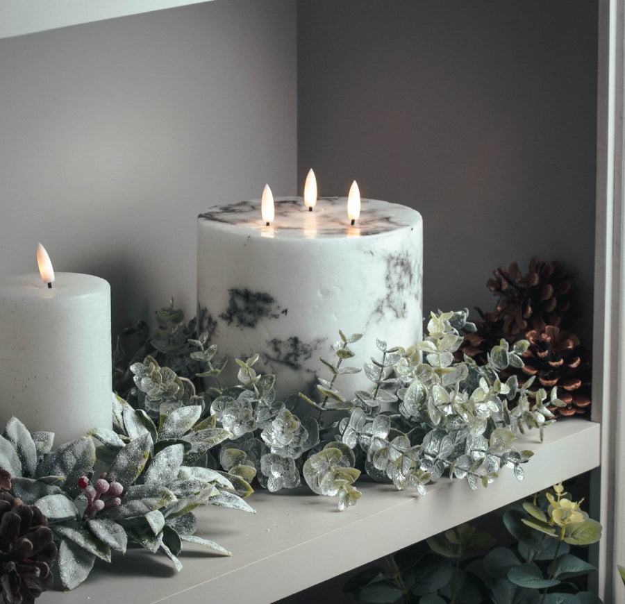 Frosted eucalyptus candle wreath with silver accents, sage green foliage, and realistic winter detailing, 33cm diameter. by Sostter at brixbailey.com