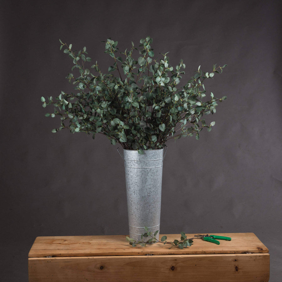 Tall faux eucalyptus stem with realistic green leaves, perfect for floor vases and home decor by Sostter at brixbailey.com