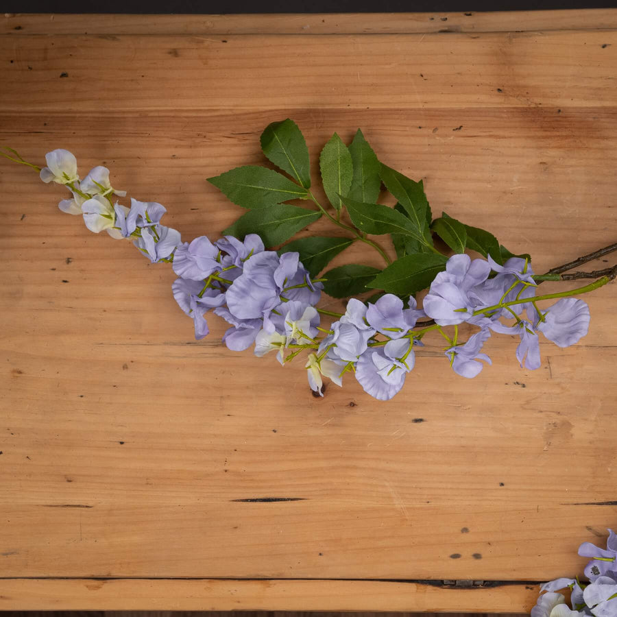 Lifelike lilac artificial wisteria with cascading clusters, soft gradients, and realistic plastic petals for home decor by Sostter at brixbailey.com