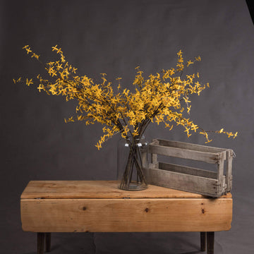 Lifelike artificial Forsythia branch with vibrant yellow flowers, hyper-realistic plastic petals, and natural stem arrangement. by Sostter at brixbailey.com