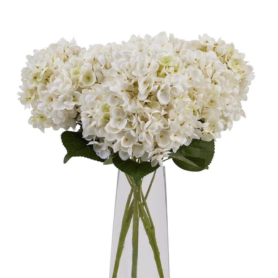 Lifelike white hydrangea floral arrangement in antique vase, handcrafted from high-quality plastic for year-round elegance. by Sostter at brixbailey.com