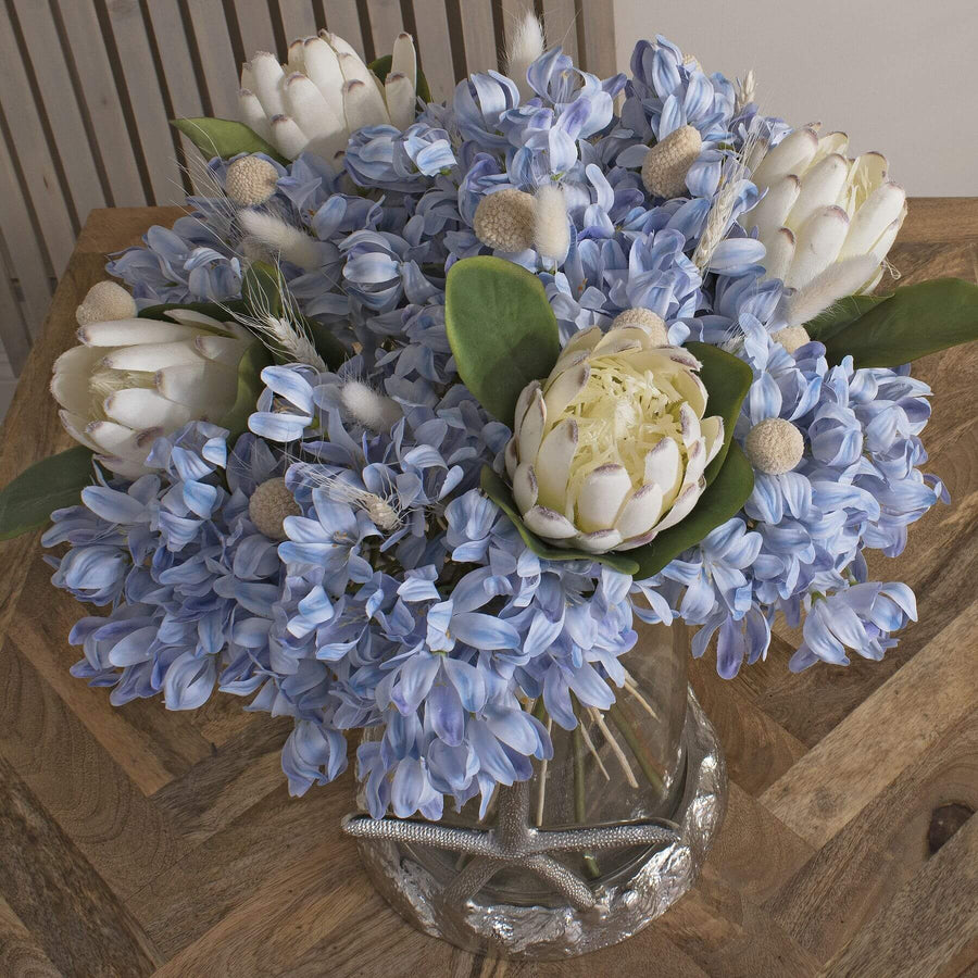 Faux white protea floral stem with hyper-realistic closed buds, 67cm tall, premium synthetic material for home decor. by Sostter at brixbailey.com