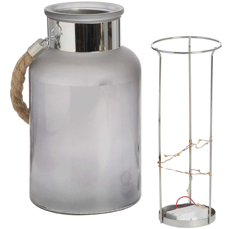 Frosted grey glass lantern with rope handle and LED lights, glowing starlight effect for indoor or outdoor ambiance. by Sostter at brixbailey.com