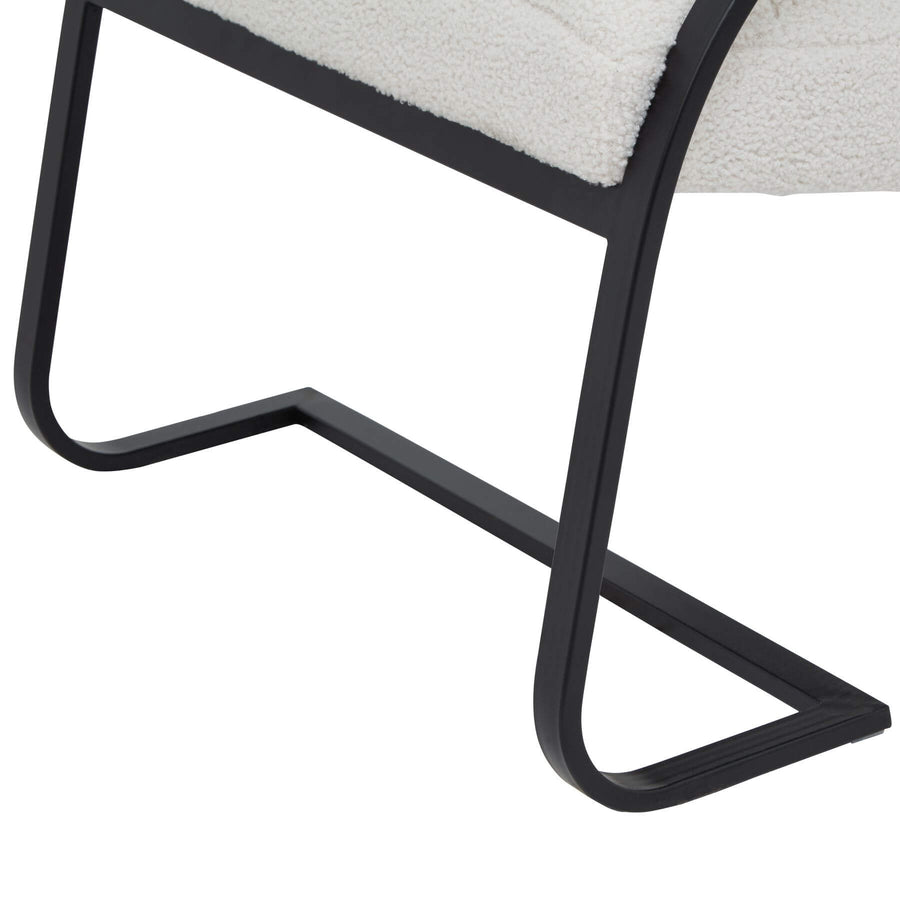 Cream boucle ribbed ark chair with curved black metal frame, channeled upholstery, and rocking motion for modern interiors by Sostter at brixbailey.com