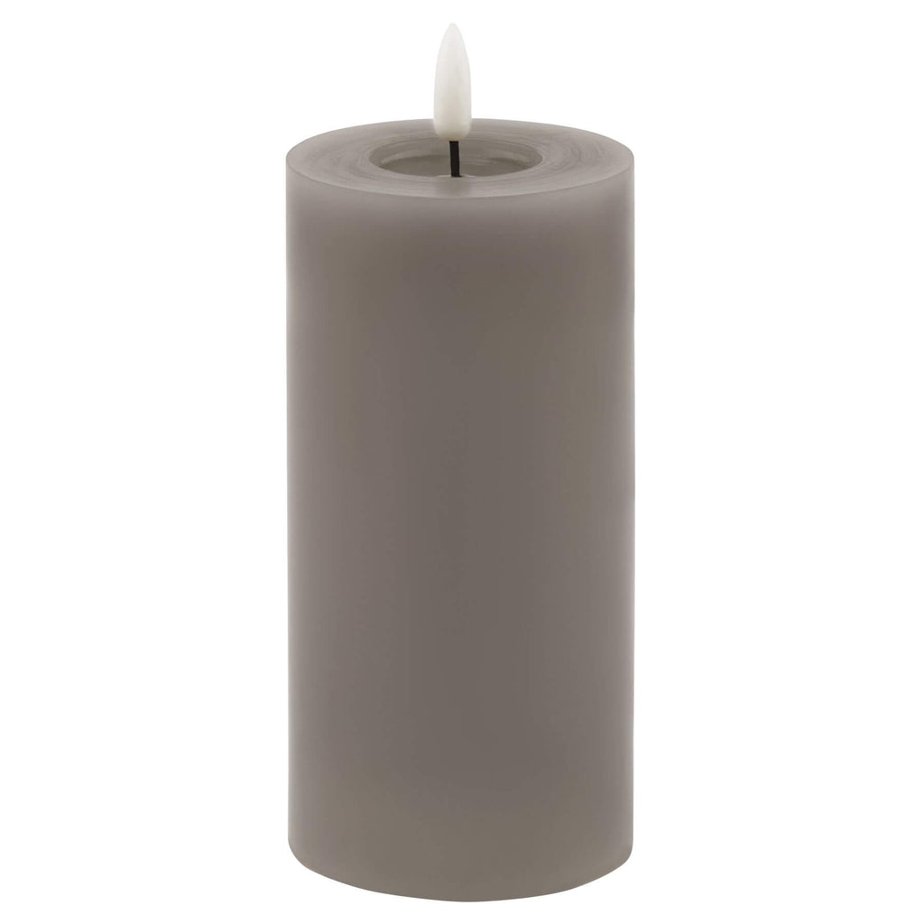 bold grey led wax candle with dramatic melt effect glowing confidently on a dark surface
